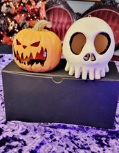 Load image into Gallery viewer, Close-up of pumpkin and skull Haunted Mansion Holiday ornaments with detailed carving